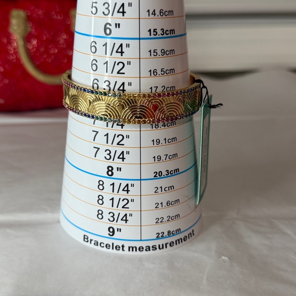 Kurt Geiger gold bangle with multi color
Stones - Picture 6 of 6
